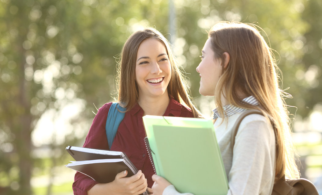 Two female students walking together on campus